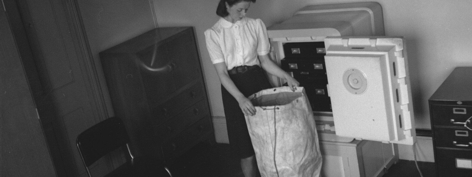 Woman taking diamonds from a safe