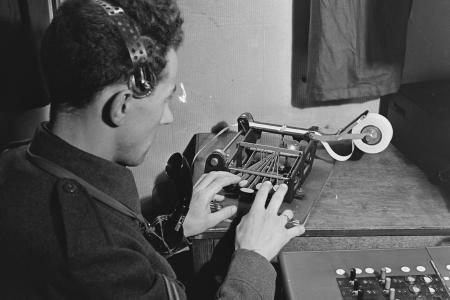 Blind telephone operator typing a message on a braille machine