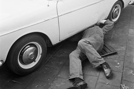 Mechanic lying under a car