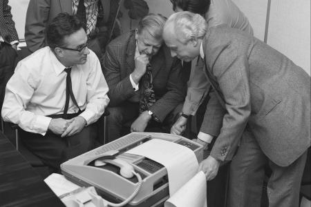 Men watching a incoming message on a fax