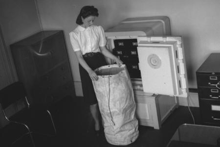 Woman taking diamonds from a safe